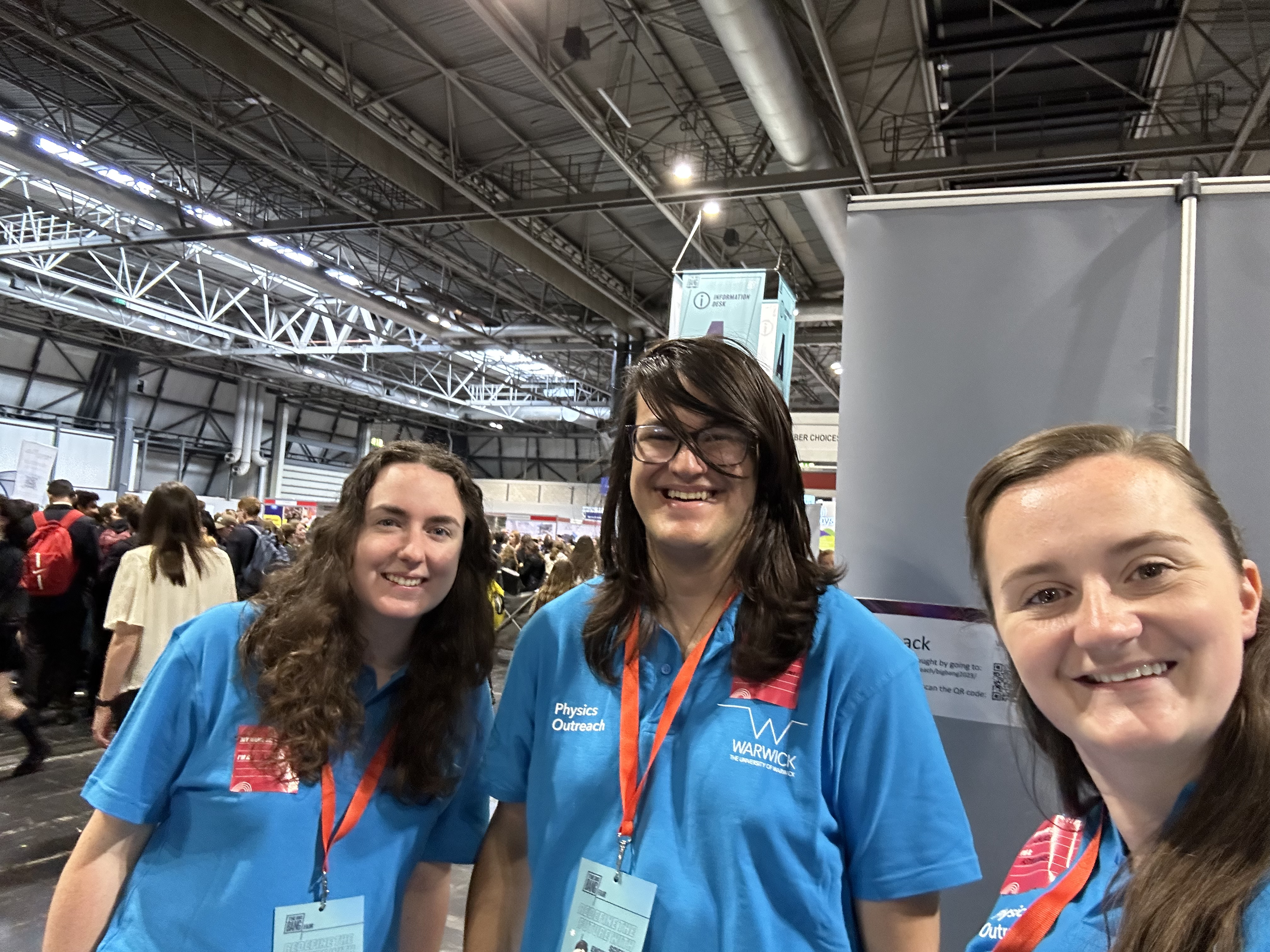 Three people stood in front of a table